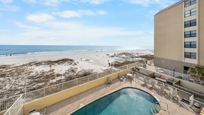 A pool area with a view of the beach and ocean. - Clearwater 2A (Gulf Shores)