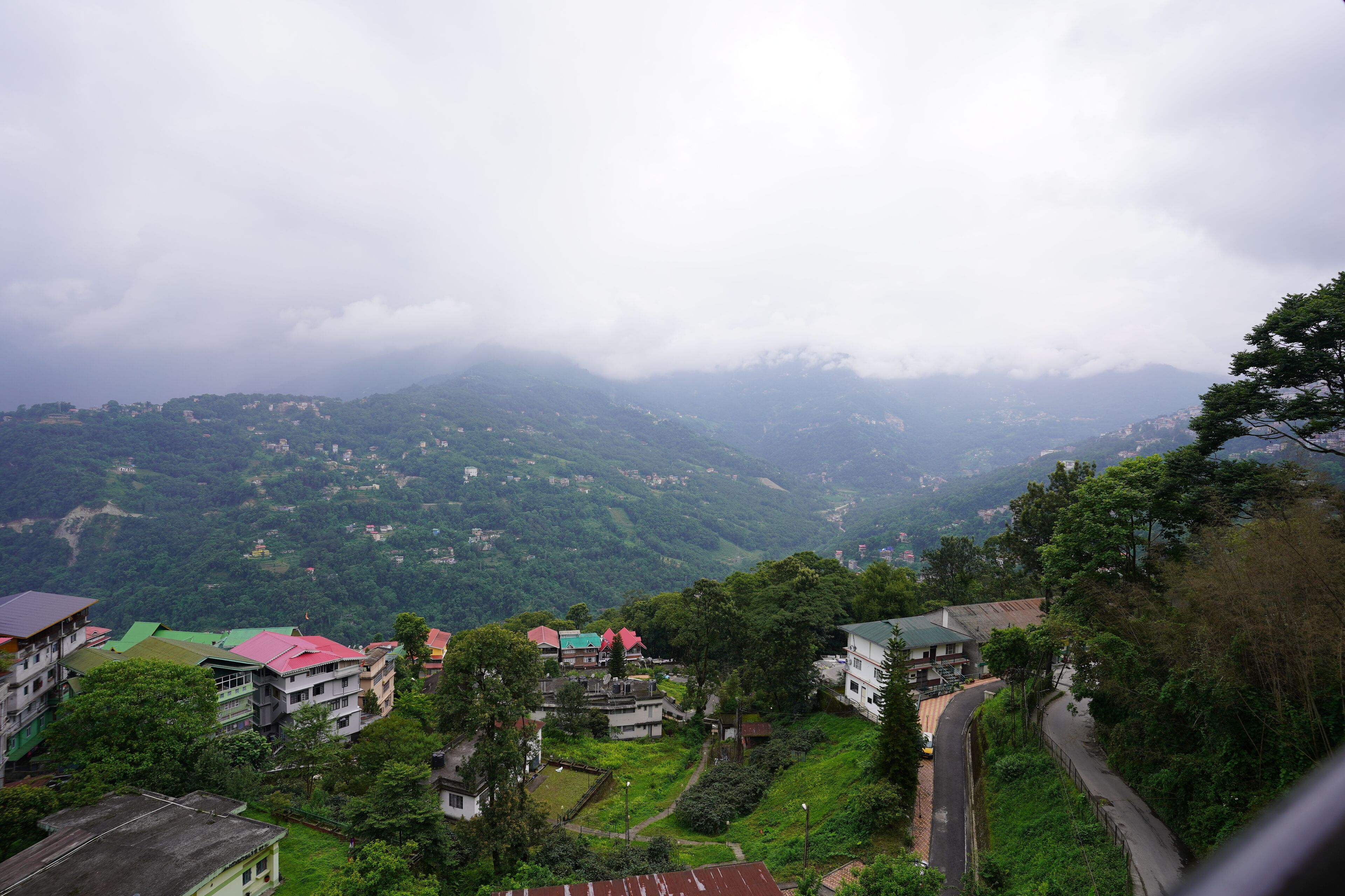 Un paisaje montañoso con edificios, carreteras y vegetación.