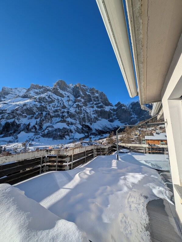 A snow-covered mountain landscape with a clear sky.