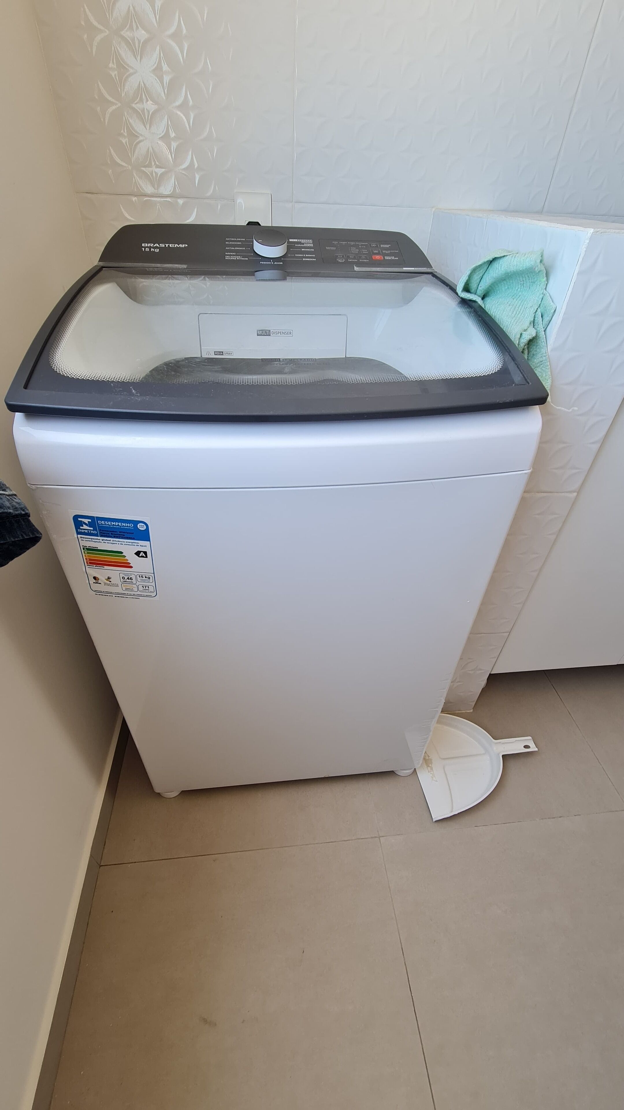 A compact, white front-loading washing machine with a transparent lid, a control panel, and a detergent label.
