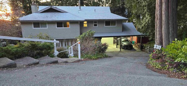 A two-story house with a garage, a driveway, and a large tree. - 5-Bedroom 4-Bathroom full house, "Breathtaking Views" (Lions Bay)