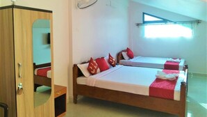 A room with two beds, a wardrobe, a mirror, a ceiling fan, and a window with a view. - Sulawado Resort (Shillong)