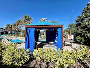 A gazebo with blue curtains, a pool area with lounge chairs, and a sign indicating a no smoking area. - Lake View! Big Screen! Resort 6 mi 2 Disney-8866 (Kissimmee)
