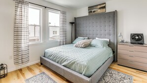 A bedroom with a bed, a dresser, a lamp, and a window with curtains. - 6 Mi to Eagles Games: Stylish Philly Townhome! (Philadelphia)