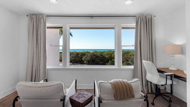 A room with a view of the ocean, two chairs, a desk with a lamp, and a small table. - Gulf views & easy beach access + Free Tickets: Bikes, Dolphin Cruise & More! (Inlet Beach)
