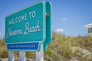 A welcome sign to Navarre Beach, Florida, stating it's the most relaxing place in Florida.