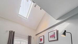 A room with a skylight, a window, a curtain rod, and two framed pictures on the wall. - Host & Stay | Roper Road (Canterbury)