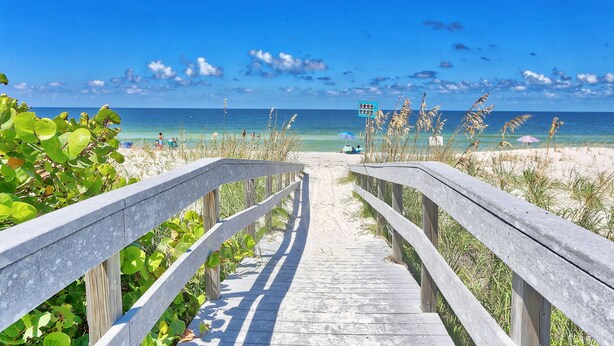 A wooden boardwalk leading to a beach with clear blue water and a sandy shore. - ⭐Unique, Stunning Views-Fantastic Location-Land's End 9-301⭐ (Treasure Island)