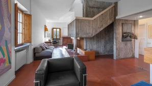 A spacious living area with a modern staircase, a sofa, and a dining area. - Il Villino Del Collezionista With Pool In Pistoia (Pistoia)