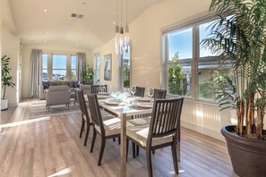 Enjoy meals in this dining area with a long table and comfortable seating.