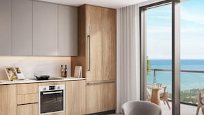 A modern kitchen with wooden cabinets and a large window overlooking the sea. - 580 Residance (Miami Beach)