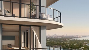 A multi-level residential building with balconies overlooking a body of water. - 580 Residance (Miami Beach)