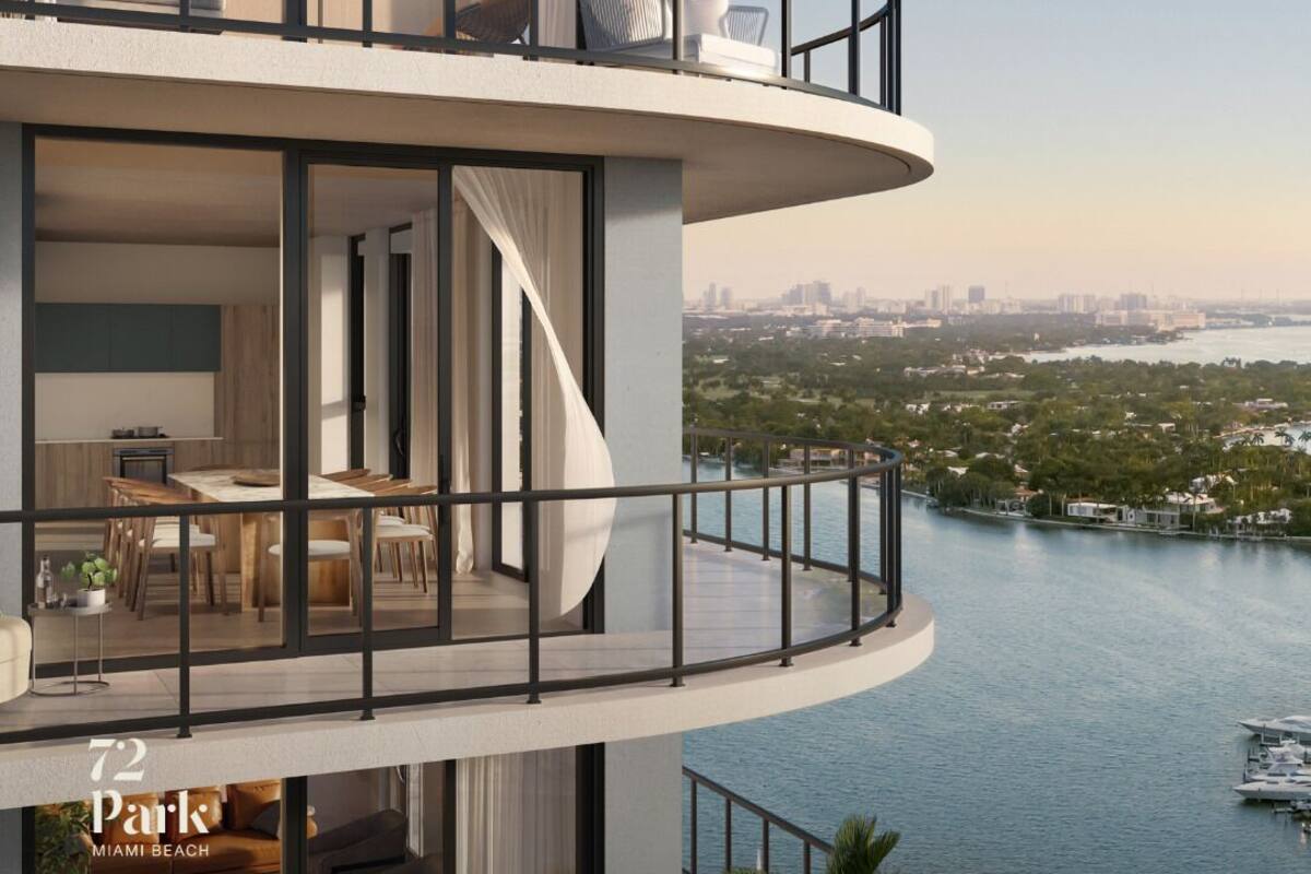 A multi-level residential building with balconies overlooking a body of water.