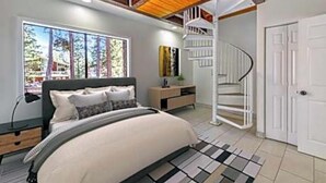 Un dormitorio con cama, mesita de noche, cómoda, ventana con vistas y una escalera de caracol.