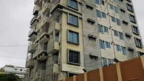 A multi-story building with balconies and windows.