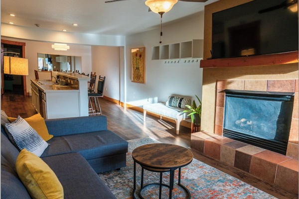 The condo has an open floor plan and a relaxing, modern, minimalist vibe.