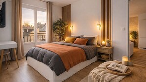 A modern bedroom with a large bed, bedside tables, a desk, and a view of the city.