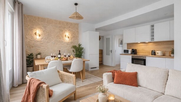 A modern living room with a sofa, chairs, a dining table, and a kitchen area.