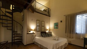 A bedroom with a bed, a staircase, and a window with curtains. - Villa Bella Vista - Paceco (Paceco)
