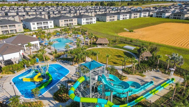 A water park with multiple slides and pools, surrounded by residential buildings. - Last Minute Disney Getaway! Townhouse with Private Pool. Book Now! #128831 (Orlando)