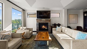 A modern living room with a fireplace, sofas, and a coffee table. - Dana Point Luxe Str14-007 (Dana Point)