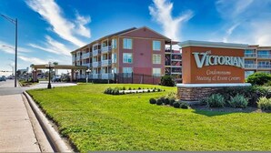 A multi-story building with a sign reading "The Victorian Condominiums Meeting & Event Centers". - Beautiful Ocean Views at The Victorian (Galveston)