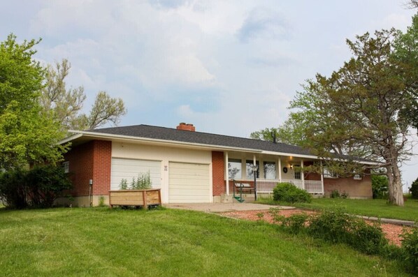 Stroll up to this charming single-story home with a cozy front porch and beautifully manicured lawn.