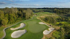 A golf course with sand bunkers, a well-maintained fairway, and a forested backdrop. - Near Manatees, Springs, Scalloping, & Black Diamond (Lecanto)