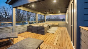 A covered outdoor deck with seating and a view of the surrounding area. - The Linden Home - Fountain Square Indianapolis (Indianapolis)