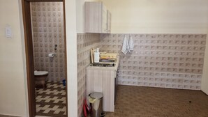 A small bathroom with a toilet, a sink, and a trash bin. - Apartments Željka - Studio Apartment with Terrace (Orebic)