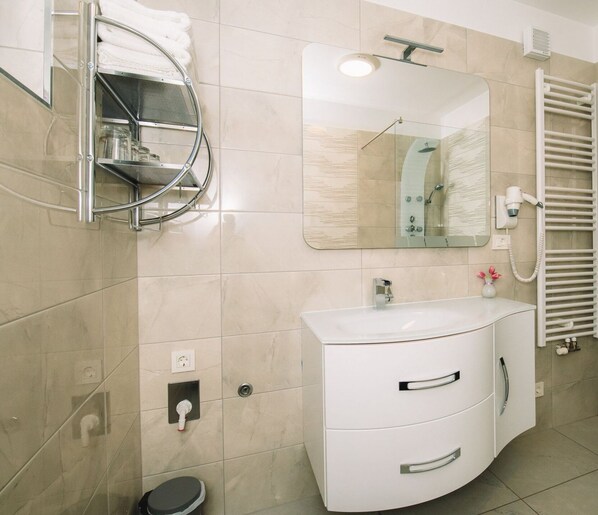 A modern bathroom with a white vanity, a glass shower enclosure, a towel rack, and a mirror. - Bled Prestigious and Stylish Apartments - Classic Studio Apartment with Terrace (Bled)