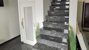 A staircase with granite steps and a white door.