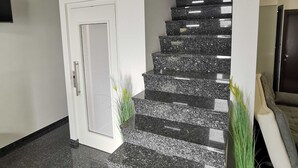 A staircase with granite steps and a white door.