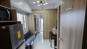 Comfort Condo, Balcony, Sea View | Living area | 42-inch Smart TV with digital channels, Netflix, streaming services - Condo next door (Pasay)