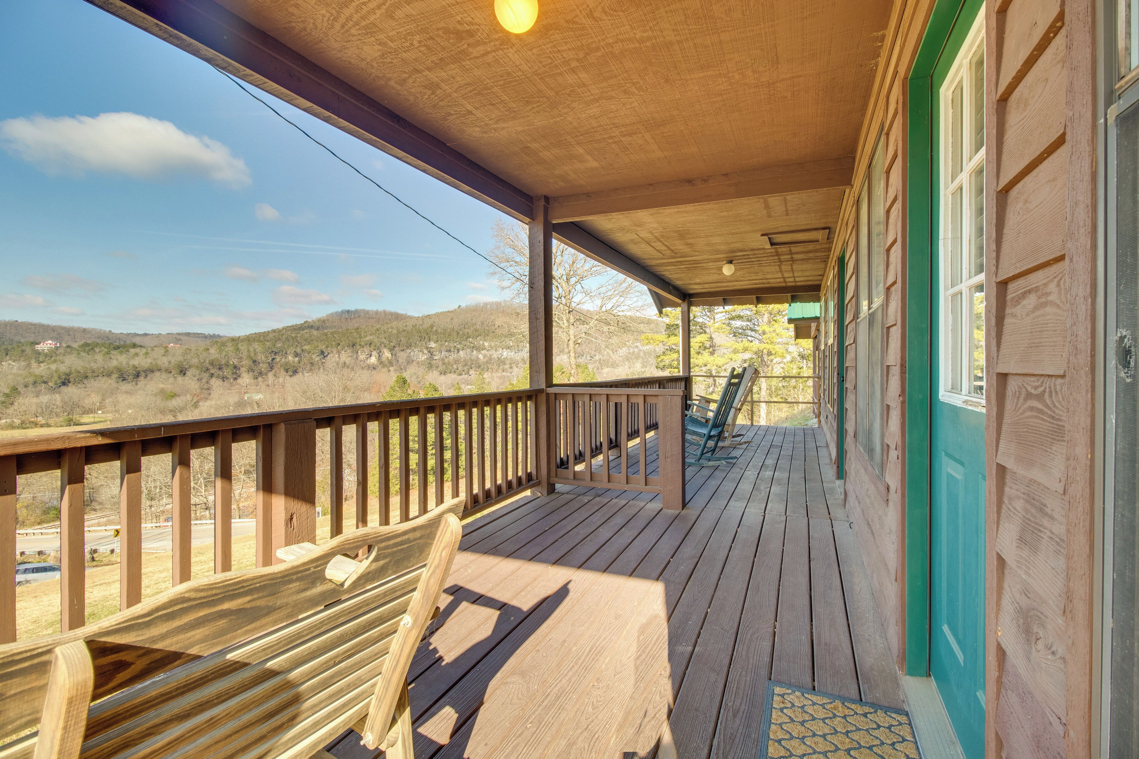 A wooden deck with a view of the countryside.