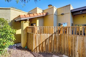 A wooden fence, a yellow building, and a clear blue sky. - 12 Mi to Dtwn Tucson: Tranquil Townhome w/ Office (Tucson)