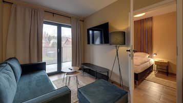Apartment, Balcony, Mountain View | Living room | Flat-screen TV