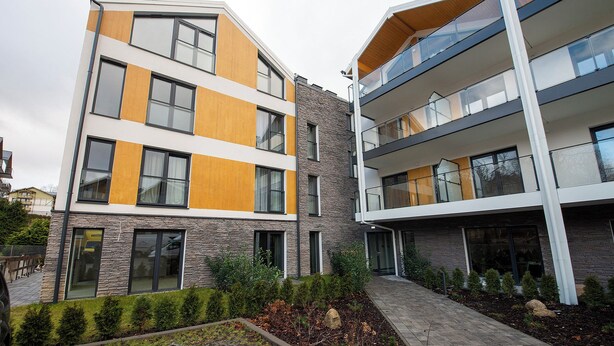 A modern multi-story residential building with balconies and large windows. - RentPlanet - Apartament Belle View (Szklarska Poreba)