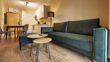 Apartment, Balcony, Mountain View | Living room | Flat-screen TV