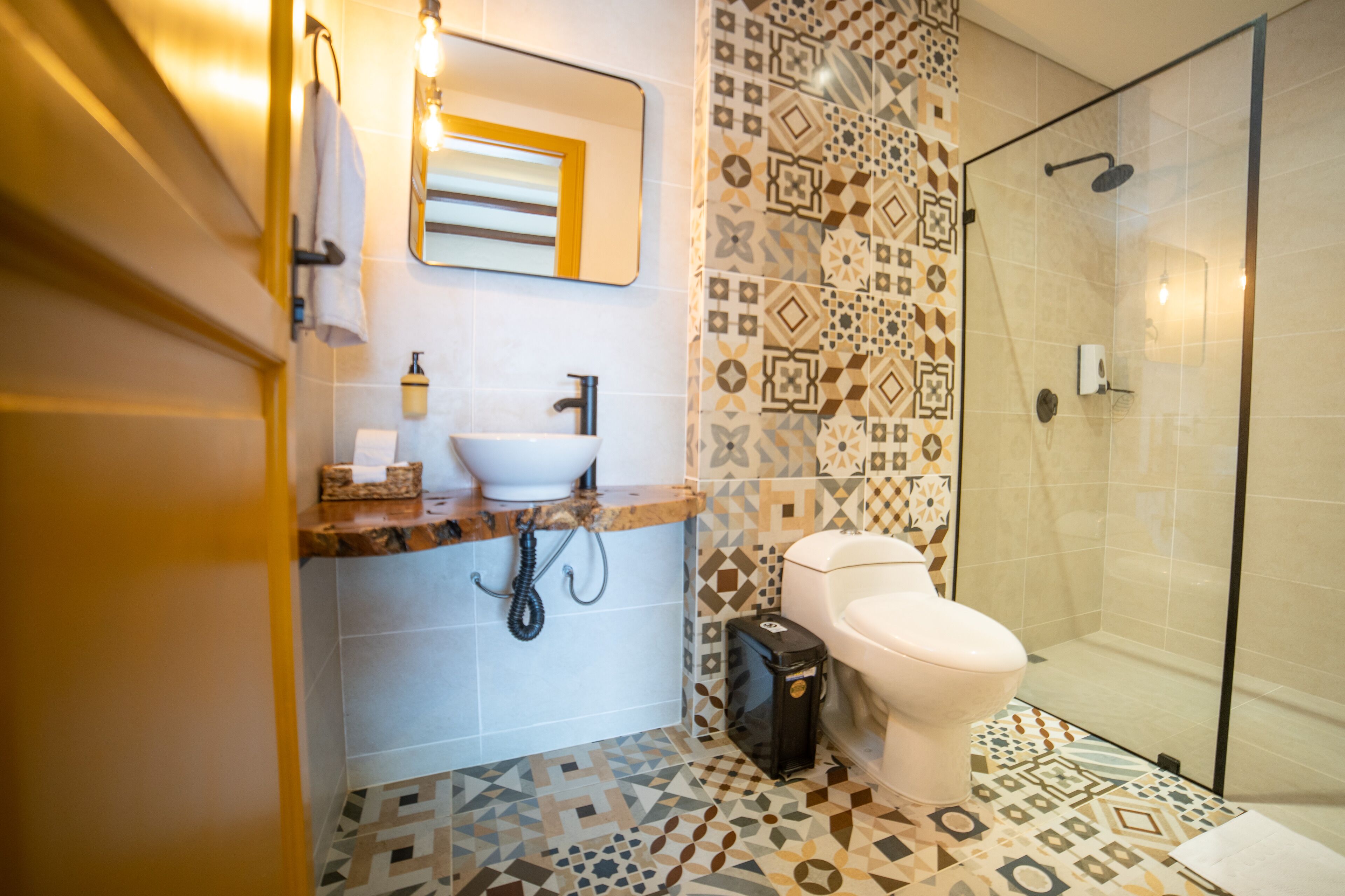 A bathroom with a white sink, a toilet, and a shower area.