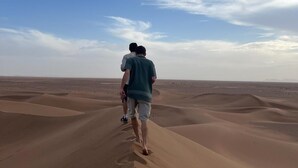 A desert landscape with sand dunes and a clear sky. - BIVOUAC CÔTE-IRIKI (Allougoum)