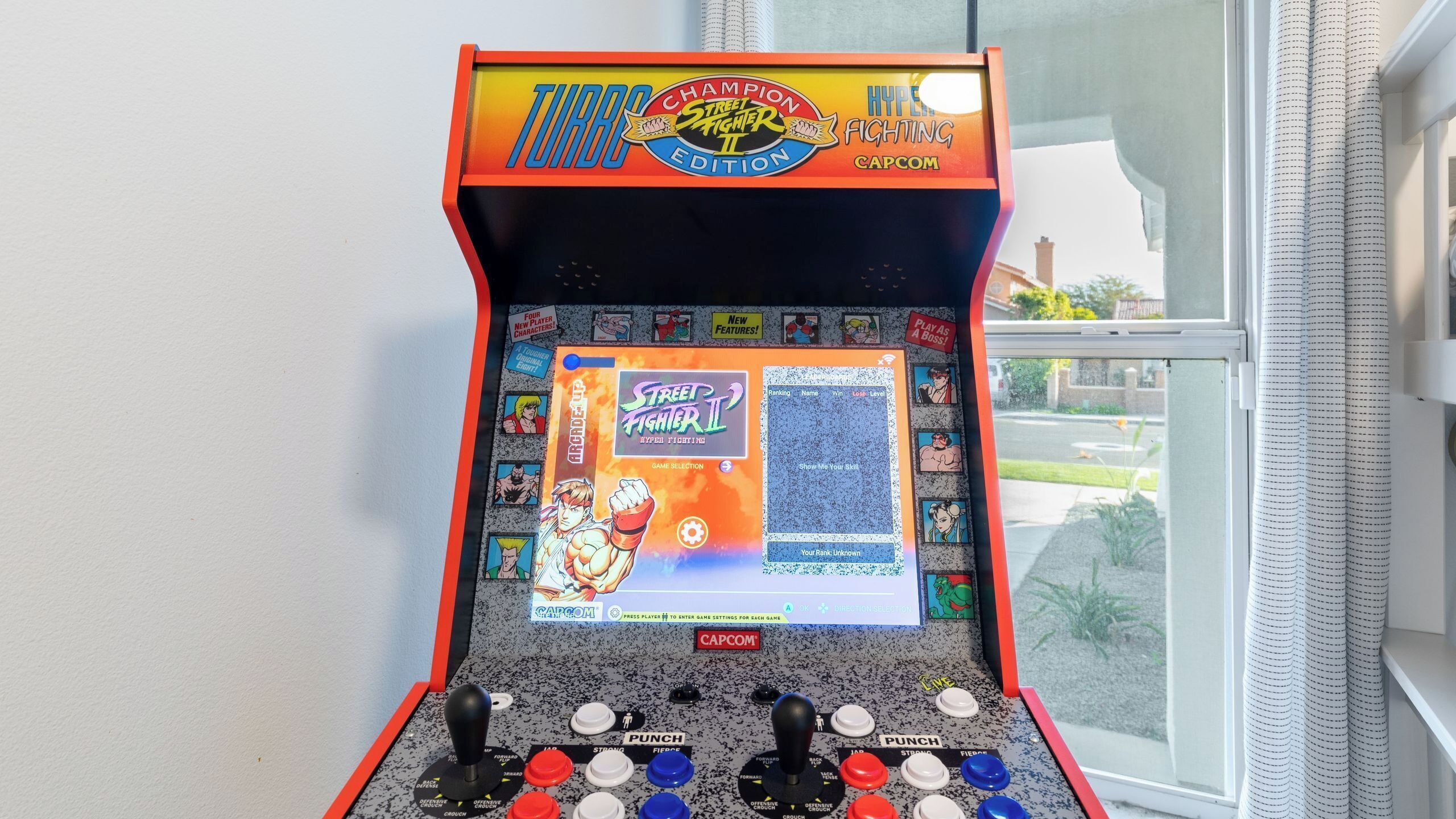 A Capcom arcade game machine with a Street Fighter II display, joystick, and buttons.