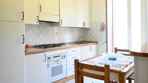 A kitchen with white cabinets, a stove, an oven, and a sink. - P044 - Porto Recanati, comfortable three-room apartment in the historic center (Porto Recanati)