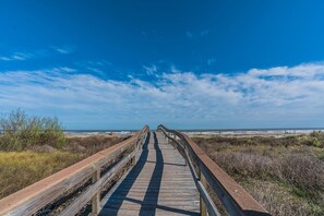 A wooden boardwalk leading to the beach with a clear sky. - Sunny Daze Walk to Beach 2 Decks Pet Friendly (Galveston)