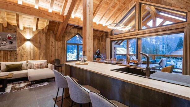 A wooden interior with a bar area, seating, and large windows. - Chalet '-Spa Le Cervin' with Mountain View, Private Terrace and Wi-Fi (Valloire)