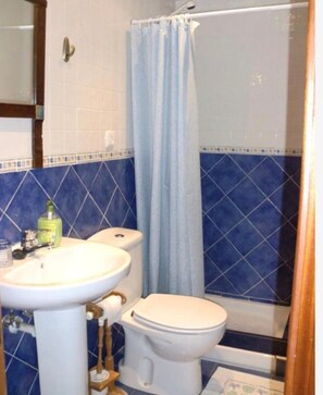 A bathroom with a sink, toilet, and shower curtain. - Apartment 'Andutz' with Mountain Views, Private Garden and Wi-Fi (Deba)