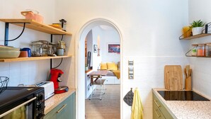 A kitchen with a microwave, toaster, and coffee maker. There is a wooden cutting board and a knife block on the counter. - Cozy renovated studio in central Biarritz - 2 min to beaches & market - Absolute calm (Biarritz)