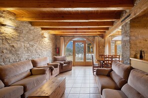 A rustic interior with stone walls, wooden beams, and a stone fireplace. - Country House 'La Serra' with Mountain View, Private Pool and Wi-Fi (Vilada)