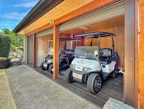 A garage with two golf carts parked inside.