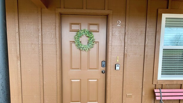 A brown wooden door with a green wreath, a mailbox, and a number '2' on the wall. - Charming, newly remodeled 2-bedroom duplex near Carthage w/ AC, fast WiFi (Carthage)